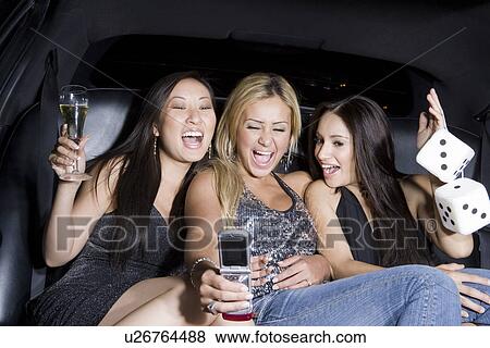 Three young women photographing self with camera phone in limousine, Las Vegas, Nevada, USA View Large Photo Image Stock Photo - Three young women photographing self with camera phone in limousine, Las Vegas, Nevada, USA. Fotosearch
