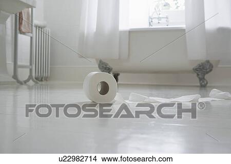 Toilet paper roll on bathroom floor View Large Photo Image Picture - Toilet paper roll on bathroom floor. Fotosearch