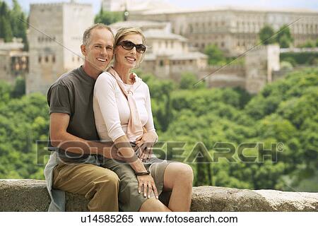 Tourist Couple sitting on Wall in Granada, Spain, portrait View Large Photo Image Stock Photography - Tourist Couple sitting on Wall in Granada, Spain, portrait. Fotosearch