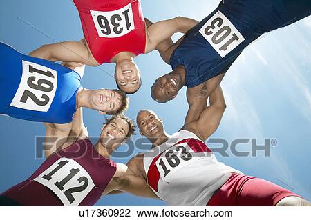 Track and field athletics smiling in a circle, view from below View Large Photo Image Stock Image - Track and field athletics smiling in a circle, view from below. Fotosearch