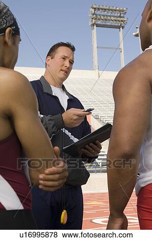 Trainer instructing runners View Large Photo Image Stock Photo - Trainer instructing runners. Fotosearch