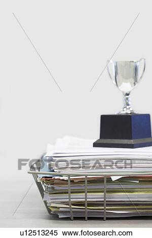 Stock Photography - Trophy on Top of Papers. Fotosearch