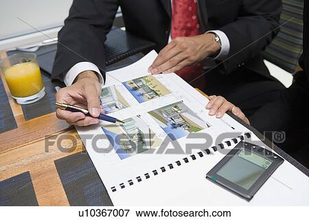 Two business people at business meeting View Large Photo Image Stock Photo - Two business people at business meeting. Fotosearch