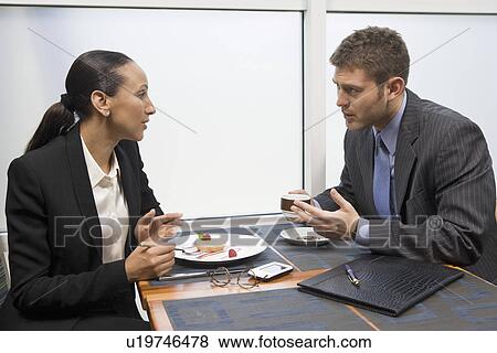 Stock Photo - Two business people having lunch. Fotosearch