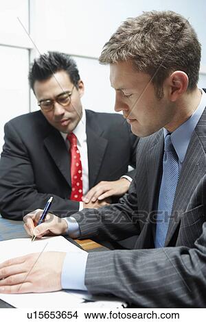 Two Businessmen in Meeting, signing contract View Large Photo Image Picture - Two Businessmen in Meeting, signing contract. Fotosearch