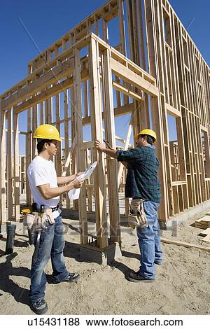 Stock Photo - Two construction workers at construction site. Fotosearch