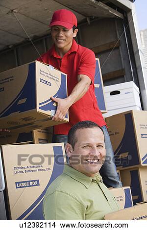 Picture - Two man unloading delivery van. Fotosearch