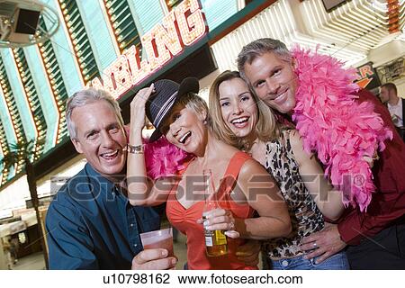 Two men and two women in front of casino building, portrait View Large Photo Image Stock Image - Two men and two women in front of casino building, portrait. Fotosearch