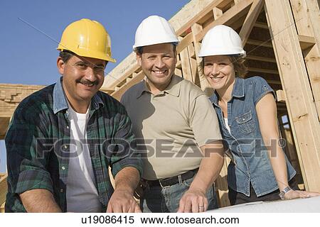 Two men and woman at construction site, portrait View Large Photo Image Stock Photography - Two men and woman at construction site, portrait. Fotosearch