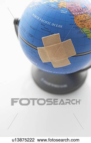 Two pieces of sticking plaster on globe, close-up View Large Photo Image Stock Image - Two pieces of sticking plaster on globe, close-up. Fotosearch