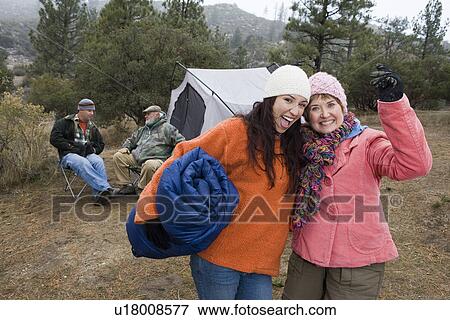 Stock Photo - Two women camping, portrait. Fotosearch