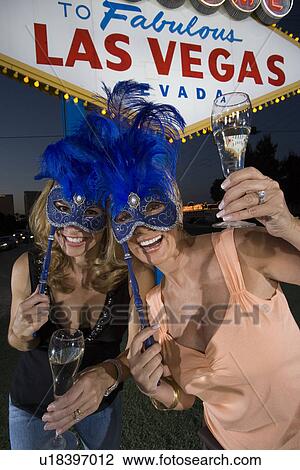 Two women celebrating in front of Welcome to Las Vegas sign View Large Photo Image Stock Image - Two women celebrating in front of Welcome to Las Vegas sign. Fotosearch