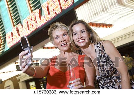 Two women in front of casino building View Large Photo Image Stock Image - Two women in front of casino building. Fotosearch