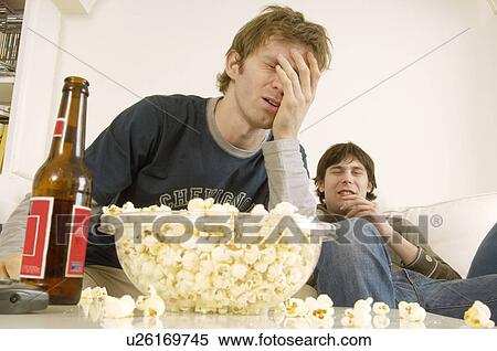 Upset Young Man on Sofa with Popcorn and Beer View Large Photo Image Stock Photography - Upset Young Man on Sofa with Popcorn and Beer. Fotosearch