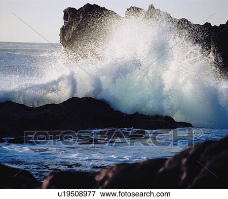 Waves crashing on rocks at coast View Large Photo Image Stock Photo - Waves crashing on rocks at coast. Fotosearch
