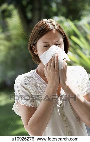 Woman Blowing Nose in garden View Large Photo Image Stock Photograph - Woman Blowing Nose in garden. Fotosearch