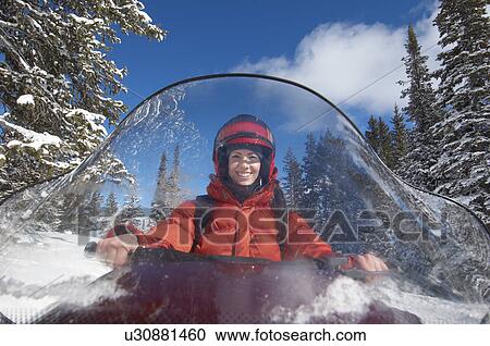 Woman driving snowmobile through snow, front view. View Large Photo Image Stock Image - Woman driving snowmobile through snow, front view.. Fotosearch