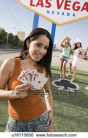 Woman holding cards in front of Las Vegas welcome sign, Nevada, USA View Large Photo Image Stock Image - Woman holding cards in front of Las Vegas welcome sign, Nevada, USA. Fotosearch