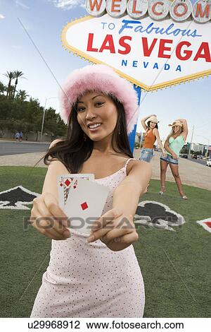 Woman holding cards in front of Las Vegas welcome sign, Nevada, USA View Large Photo Image Stock Image - Woman holding cards in front of Las Vegas welcome sign, Nevada, USA. Fotosearch