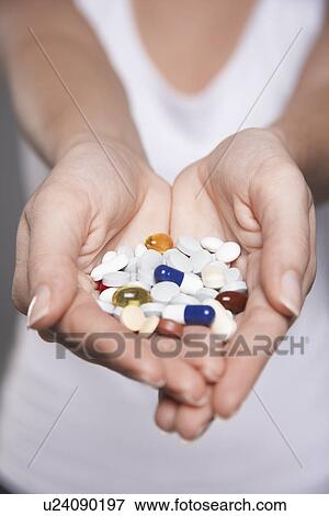 Woman holding pills in hands, close-up on hands View Large Photo Image Stock Photo - Woman holding pills in hands, close-up on hands. Fotosearch