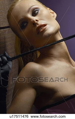 Stock Photograph - Woman holding whip, close-up, portrait. Fotosearch