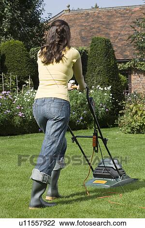 Stock Image - Woman Mowing Lawn. Fotosearch