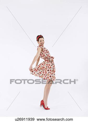 Stock Photo - Woman posing in studio, full length. Fotosearch