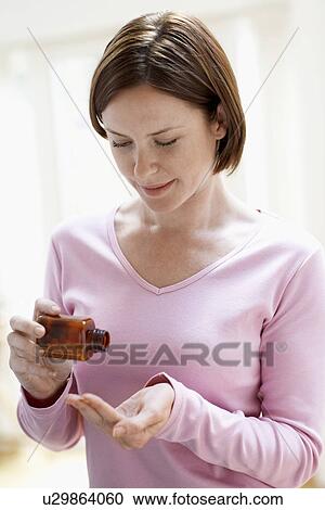 Woman pouring pills in hand View Large Photo Image Stock Image - Woman pouring pills in hand. Fotosearch