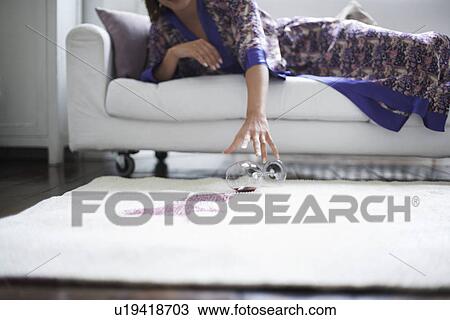 Woman reaching for spilled wine glass View Large Photo Image Stock Image - Woman reaching for spilled wine glass. Fotosearch
