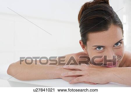 Stock Image - Woman relaxing in bathtub, close-up, portrait. Fotosearch