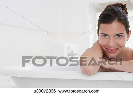Woman relaxing in bathtub, portrait View Large Photo Image Stock Photograph - Woman relaxing in bathtub, portrait. Fotosearch