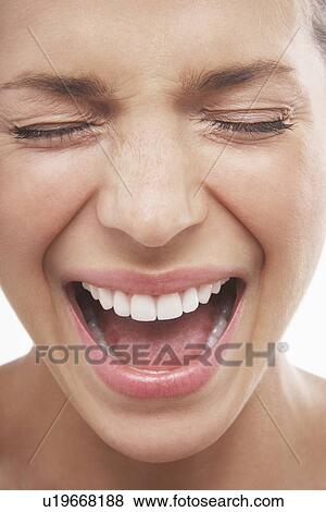 Woman screams with open mouth and closed eyes View Large Photo Image Stock Photo - Woman screams with open mouth and closed eyes. Fotosearch