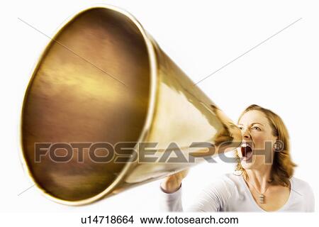 Picture - Woman shouting through megaphone, studio shot. Fotosearch
