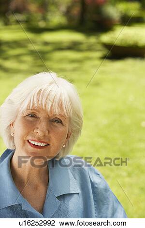 Woman Sitting in back yard, portrait View Large Photo Image Stock Image - Woman Sitting in back yard, portrait. Fotosearch