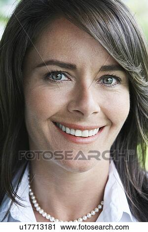 Stock Image - Woman smiling, close-up, portrait. Fotosearch
