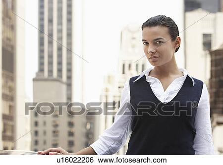 Woman standing on balcony with skyscrapers behind, half length View Large Photo Image Stock Photograph - Woman standing on balcony with skyscrapers behind, half length. Fotosearch