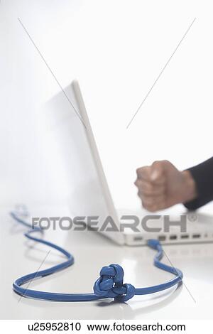 Woman using lap top with knotted cable in studio, close up on knot View Large Photo Image Stock Image - Woman using lap top with knotted cable in studio, close up on knot. Fotosearch