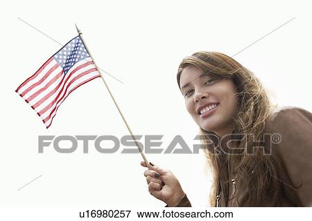 Stock Photo - Woman waving American flag, head and shoulders. Fotosearch