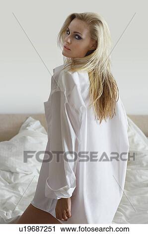 Woman wearing shirt in bedroom, portrait View Large Photo Image Stock Image - Woman wearing shirt in bedroom, portrait. Fotosearch