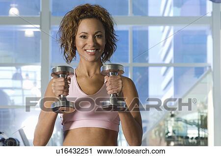 Stock Image - Woman Weightlifting With Dumbbell. Fotosearch