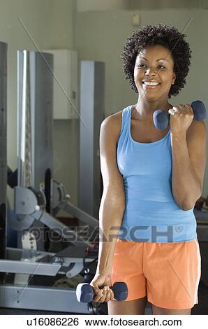 Stock Photograph - Woman Weightlifting with Dumbbells. Fotosearch