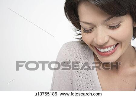 Woman with large smile, eyes closed, close-up View Large Photo Image Stock Photograph - Woman with large smile, eyes closed, close-up. Fotosearch