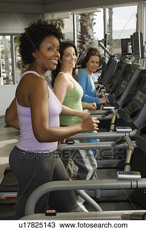 Women Exercising on Treadmills at Health Club View Large Photo Image Stock Image - Women Exercising on Treadmills at Health Club. Fotosearch