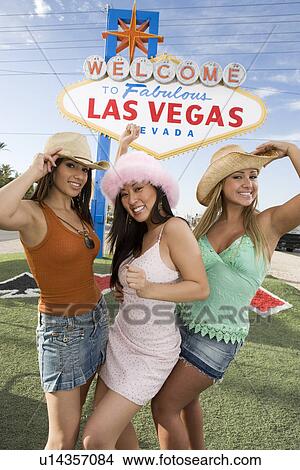 Women posing in front of Las Vegas welcome sign, Nevada, USA View Large Photo Image Picture - Women posing in front of Las Vegas welcome sign, Nevada, USA. Fotosearch