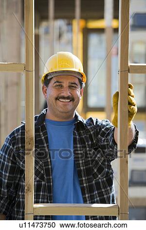 Stock Image - Worker in construction site. Fotosearch