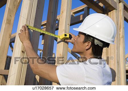Stock Photo - Worker in construction site. Fotosearch