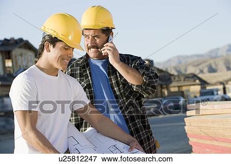 Workers in construction site View Large Photo Image Stock Photo - Workers in construction site. Fotosearch