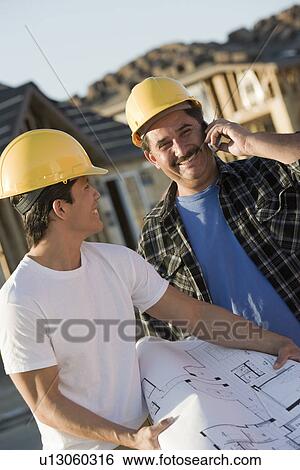 Workers in construction site View Large Photo Image Stock Photograph - Workers in construction site. Fotosearch