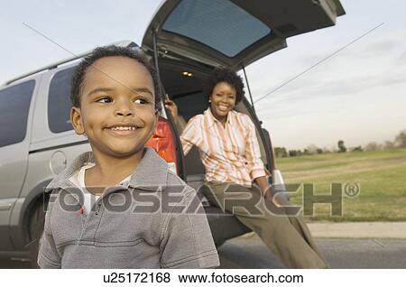 Young boy and mother by open car boot View Large Photo Image Stock Photo - Young boy and mother by open car boot. Fotosearch