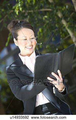 Young business woman with diary, outdoors View Large Photo Image Stock Image - Young business woman with diary, outdoors. Fotosearch